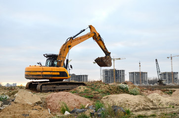 Excavator digs the ground for the foundation and construction of a new building. Road repair,...