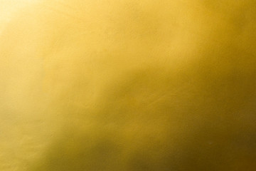 Gold texture background with yellow luxury shiny shine glitter sparkle of bright light reflection on golden surface