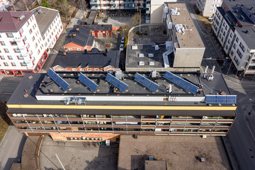 Solar panels on the roof of an apartment building, aerial view