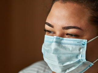 Beautiful Women In A Medical Mask. Close-up of a young girl with a surgical mask on her face...