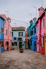 Fototapeta na wymiar Colorful houses and clothes hanging in Burano, Venice, Italy