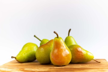 Delicious pears on a wooden tray isolated on a white background