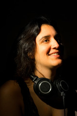 Pretty girl over dark background with a headphones