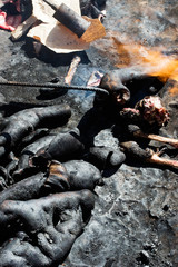 Burning camel's skin with torch, Morocco 