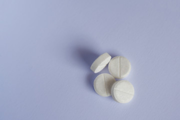 pile of pills on blue background with copy space. medicine concept