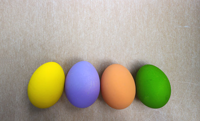 Four colorful easter eggs on a paper background

