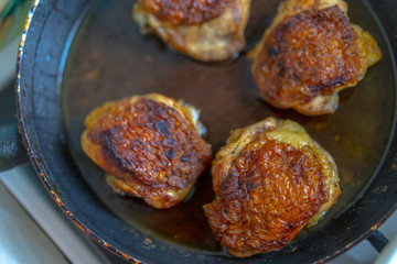 Pieces of chicken in a pan