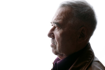 Portrait of old man on white background. Aged male in profile. Free space for text.