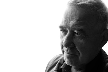 Obraz premium Black and white portrait of old man on white background. Aged male in profile. Free space for text.