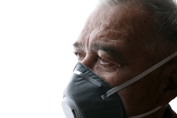 Old man in protective respirator. Male wearing medical mask. Free space for text. Coronavirus 2019-nCov.