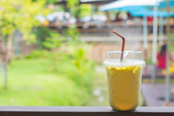 Glass of cold green tea  on  iron balconies Background blurry views tree.