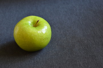 green apple on a black table