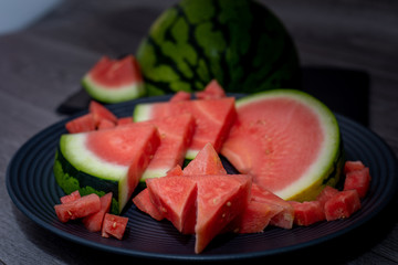 Plate with tasty sliced watermelon on table