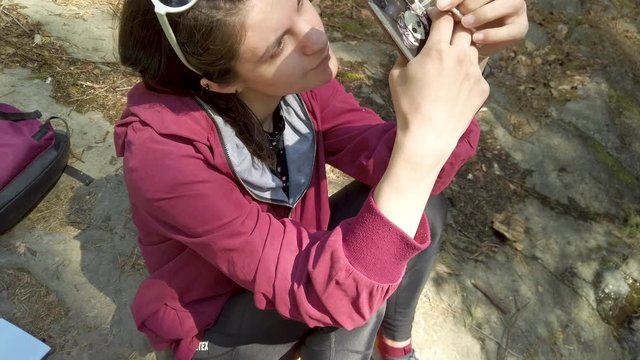 Female taking photos at the nature  using smartphone and polyhedral crystal.