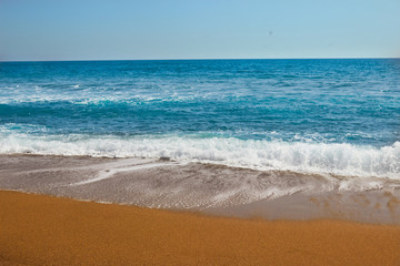 Blue sea waves at the Mediterranean beach in Antalya, Turkey.