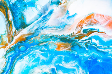 Fluid art texture. Backdrop with abstract iridescent paint effect. Liquid acrylic picture with beautiful mixed paints. Can be used for interior poster. Blue, golden and white overflowing colors