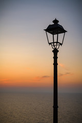 Obraz premium Siluette of old lamp with views on Mediterranean sea
