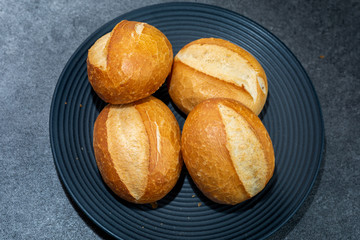 A few freshly baked bread rolls on dark background