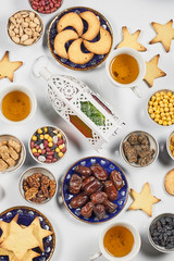 Iftar foods on white table. Traditional middle-eastern lunch with cookies and sweets