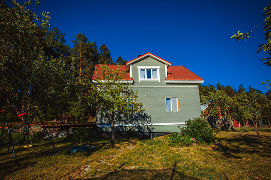 Typical Gray Finnish House In The Field