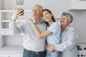 Couple in a room. Grandparents sitting at home. Family with mobile phone