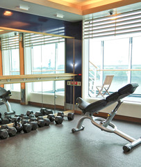 Staying fit with weight fitness equipment and machines in gym or fitness center on modern...
