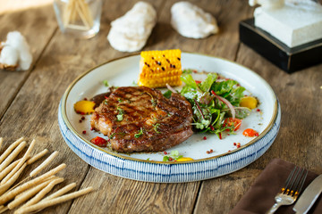 Appetizing juicy pork chop with a corn 