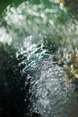 splash and drops of water on abstract background with white, black, blue and yellow