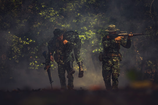 army soldier with rifle and machine gun moving .Thai army soldier in combat uniforms with machine gun.