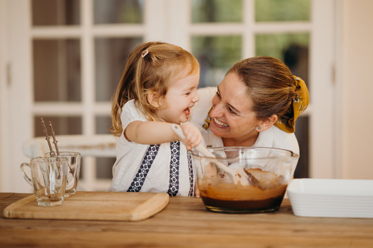 Loving Beautiful Mother And Daughter Cooking Together A Chocolate Brownie And Having Fun