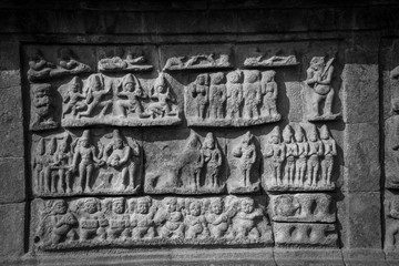 A black and white picture of intricate carvings on the walls of bragadeeswarar temple in Tamil Nadu India