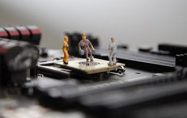 miniature people Motherboard and  CPU repair, Concept: working in technical teams, 
technology systems Behind the maintenance engineering,  Computer Hardware  for memory, closeup mini top view
