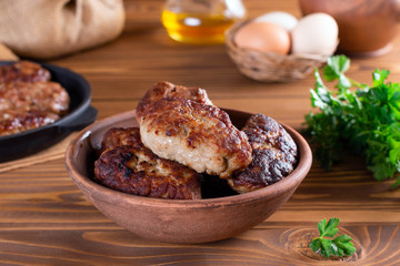 Homemade cutlets in a ceramic bowl