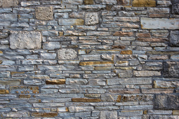 old stone wall background with different colours and sizes