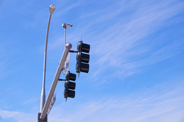 Traffic lights at the intersection of streets in the city. Mounted traffic monitoring system.