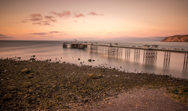 Sunset over Llandudno pier at low tide