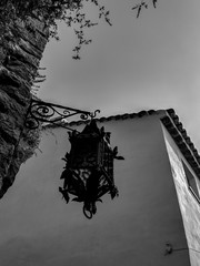 Black and White Photography of a Closeup of a street light lamp on a narrow old French village