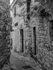 Fototapeta na wymiar Black and White Photography of a Beautiful architecture of a narrow street of the old town of Eze on Cote d'Azur