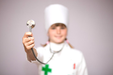 Teenager girl wearing in medical uniform with stethoscope isolated on white. Coronavirus Quarantine Concept.
