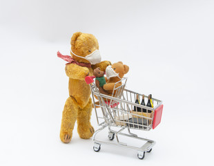 Teddy bears in medical mask go shopping with a pushcart - family shopping with virus prevention