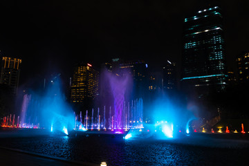 Fototapeta na wymiar Night view of the dancing multi-colored fountains. Show of Singing Fountains