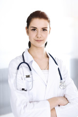 Doctor woman cheerful smiling at camera. Perfect medical service in clinic. Happy future in medicine and healthcare