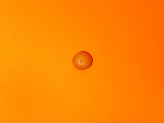 Colorful fruit pattern of fresh mandarins on an orange background. Top view