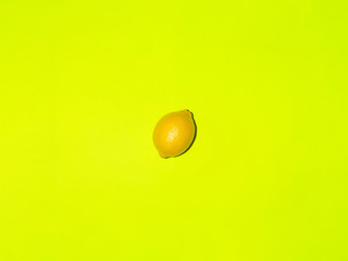 Colorful fruit of fresh lemons on a light green background. Top view