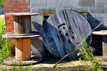 Cable Spools Stacked by Old Building