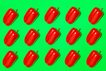 Colorful pattern of fresh pepper on a green background. Top view