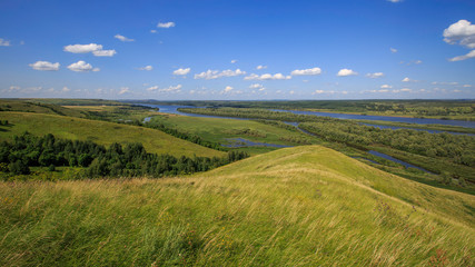 beautiful hills on the high bank of the river Vyatka on a sunny day in summer