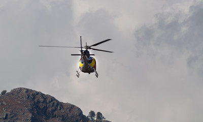 Zoomed shot of a flying Chopper from behind in Disaster Management concept.