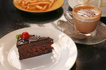 Delicious chocolate cake and cup of coffee.