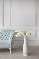 Baroque sofa. Vintage furniture. Pastel blue sofa with carriage tie. Restoration of vintage furniture. Furniture manufacturing. Interior design. Copy space.